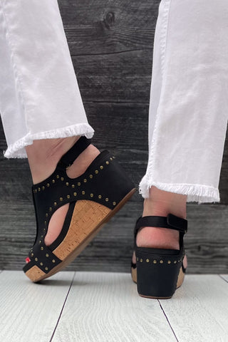 Corkys Footwear Carley Wedge Sandal in Black Oil PU with Studs is a closet staple