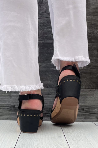 Corkys Footwear Carley Wedge Sandal in Black Oil PU with Studs is a closet staple