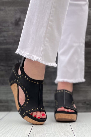 Corkys Footwear Carley Wedge Sandal in Black Oil PU with Studs is a closet staple