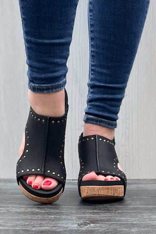 Corkys Footwear Carley Wedge Sandal in Black Oil PU with Studs is a closet staple