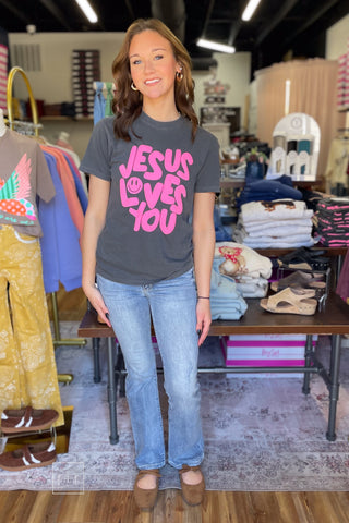 Model wearing the Poppy & Pine Jesus Loves You Smiley Puff Tee with hot pink puff ink lettering in a relaxed fit