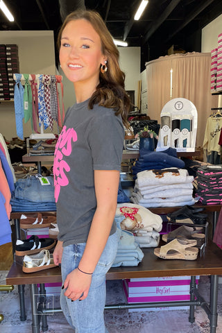 Poppy & Pine Jesus Loves You Smiley Puff Tee in charcoal with hot pink puff ink lettering, model wearing size small