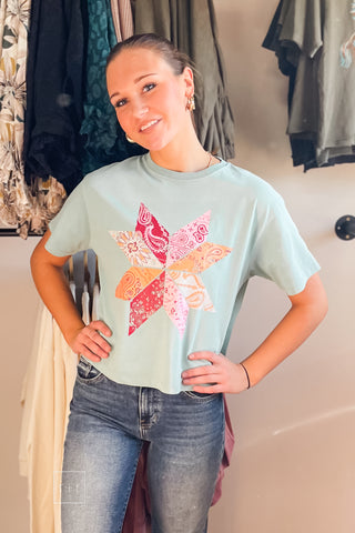 Model in the Poppy & Pine Bandana Pinwheel Cropped Tee showing the boxy cropped fit and bandana quilt star graphic