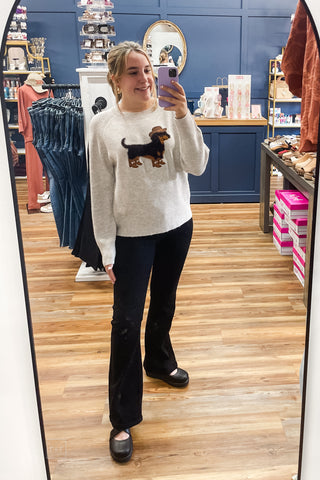Full-length mirror view of the ee:some cowboy dachshund sweater SH17268 styled with Judy Blue Black Bootcut Jeans JB881184 and Corkys Footwear Black Whats The Rush wedge shoes