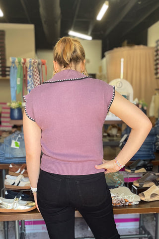 Full back view of the dusty plum knit polo top showing the ribbed hem and relaxed fit.