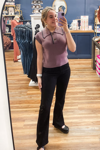 Full-length view of the dusty plum knit polo top styled with Juyd Blue black bootcut jeans and Corkys Bring It In black wedge closed toe shoes