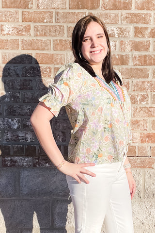 eesome light olive green with all over pastel floral pattern and colorful embroidery framing v-neck with short puff sleeves and elastic ruffle cuff TK14695