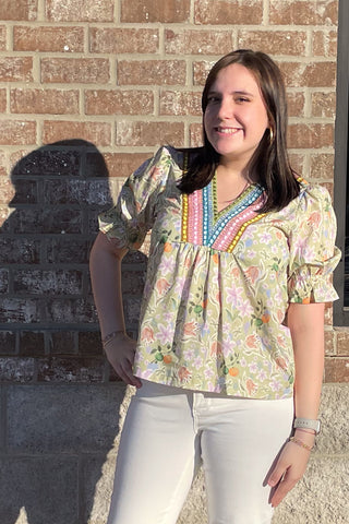 eesome light olive green with all over pastel floral pattern and colorful embroidery framing v-neck with short puff sleeves and elastic ruffle cuff TK14695