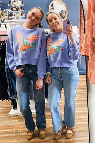 Two models posing together in the Poppy & Pine How Ducky Are We purple crop sweatshirt, both wearing size Small/Medium