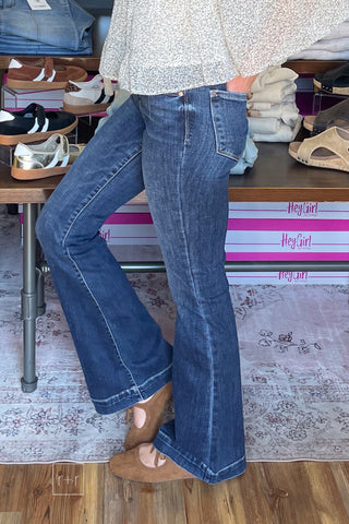 Side view of Judy Blue 82637 dark wash trouser flare jeans showing the high rise and flare hem