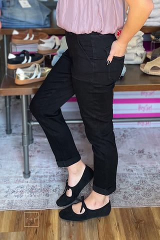 Judy Blue High Waist Aurora Weekender Jeans in Jet Black JB881217 angled view showing the patch pockets and double rolled cuff with Corkys Layover black ballet flats
