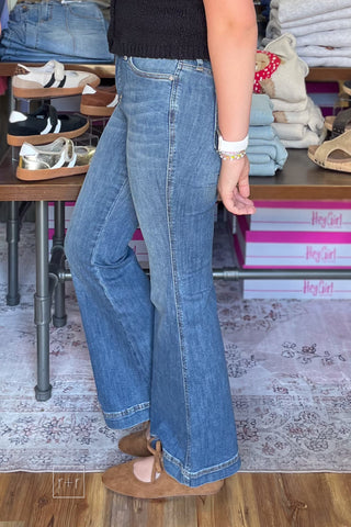 Side view of Judy Blue petite high rise tummy control trouser flares 881018PT showing the flare leg silhouette with Corkys Layover ballet flats in camel