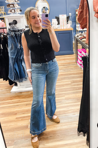 Mirror photo of Judy Blue petite tummy control trouser flares 881018PT in size 3/26, styled with the black Margot sleeveless cardigan and Corkys Layover ballet flats in camel