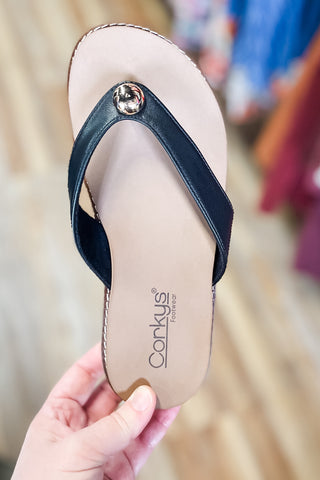 Corkys Footwear Off The Deep End Thong Flip Flop Sandals in Black with low wedge and cushioned insole. gold button charm detail