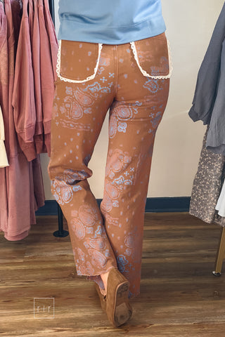 Back view of Poppy & Pine brown paisley bandana high rise jeans with blue bandana print