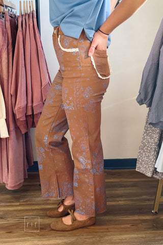 Side view of Poppy & Pine brown paisley bandana high rise jeans showing the relaxed straight leg and frayed hem