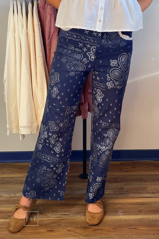 Front view of Poppy & Pine navy paisley bandana jeans with white print and raw fray hem