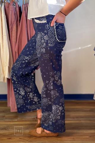 Side view of Poppy & Pine navy paisley bandana high rise jeans with lace-trimmed pockets