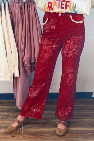 Poppy & Pine red paisley bandana jeans styled with a cream graphic sweatshirt and tan suede bow ballet flats