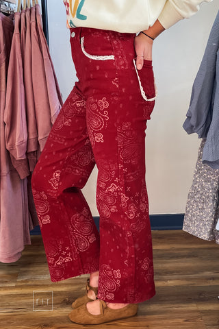 Side view of Poppy & Pine red paisley bandana high rise jeans showing the relaxed straight leg and frayed hem