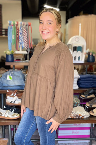 Side angle of the Umgee N7223 almond brown crinkle babydoll top with Risen high rise flare jeans