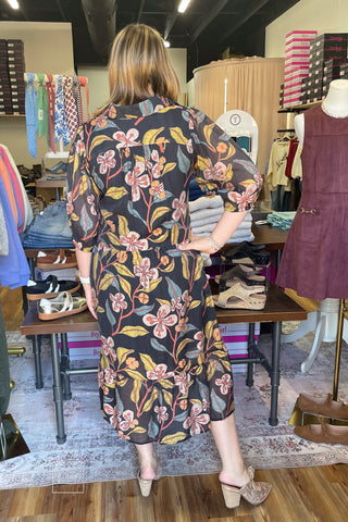 Umgee K0651 black fall floral midi dress, angled view with Corkys Knot Gonna Happen Mules in gold