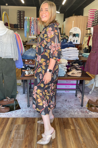 Umgee K0651 black floral midi dress, side view with Corkys Knot Gonna Happen Mules in gold