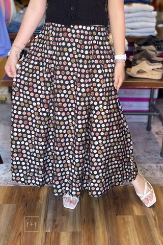 Close-up of the Umgee C6942 black polka dot pleated maxi skirt