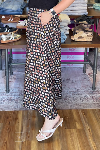 Umgee C6942 black pleated maxi skirt showing the flowy A-line shape