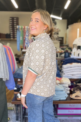 Angled side view of the Umgee taupe jacquard floral top C6449 with contrast cuffs, paired with Risen cropped wide leg jeans.