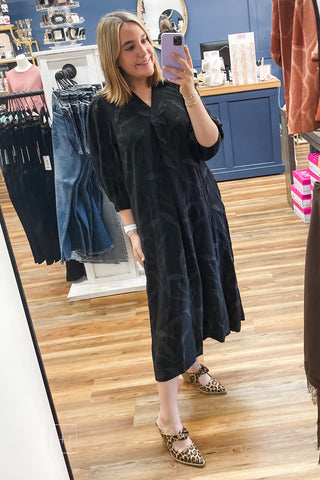 Umgee C6760 black leaf jacquard midi dress with split V-neckline and relaxed, flowy fit, paired with Corkys Knot Gonna Happen heeled mules in leopard