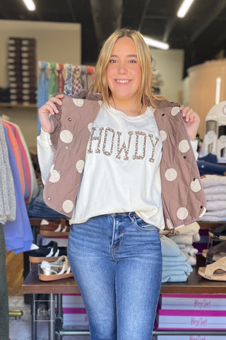 Umgee C6829 mocha quilted ruffle vest worn open over the Wishlist Howdy floral graphic sweatshirt WL26-12822 with Risen High Rise Flare Jeans