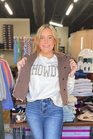 Umgee C6829 reversible quilted vest in mocha layered over the Wishlist Howdy floral graphic sweatshirt with Risen High Rise Flare Jeans PF21438