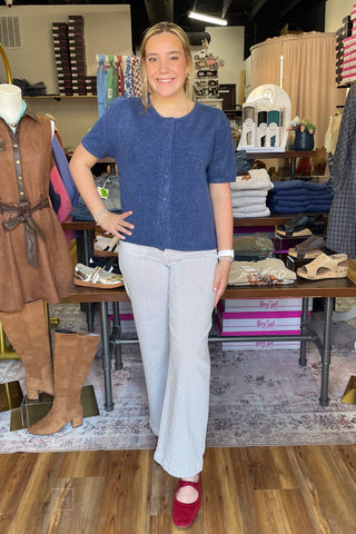 Front view of the Umgee denim blue short sleeve knit cardigan D1148 paired with Just Black Denim Navy Pin Stripe Patch Pocket Wide Leg Jeans and Hey Girl by Corkys Layover Ballet Flats in red
