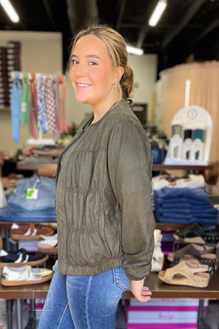 Side view of the Umgee Shayla olive suede-look zip up jacket N7068 showing the ribbed side panel detail