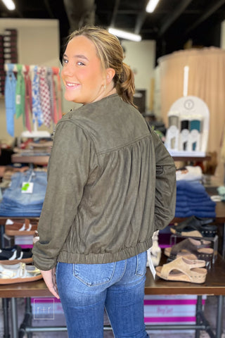 Over-the-shoulder view of the Umgee Shayla olive suede-look zip up jacket N7068 showing the back yoke and shoulder detail