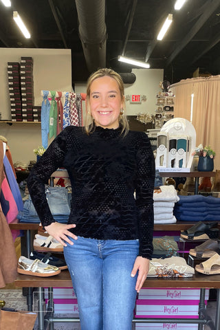 Front view of the Umgee D1256 black velvet burnout mock neck top in size small, fitted through the body