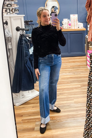 Mirror photo of the Umgee D1256 black velvet burnout mock neck top styled with Risen High Rise Wide Leg Jeans With Wide Cuff and Corkys Layover Ballet Flats