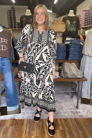 Umgee Black Botanical Print Tiered Midi Dress Long Balloon Sleeves D1177 front view with Caroline Hill black quilted purse