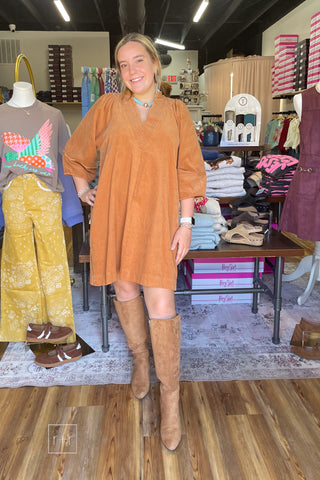Model wearing the Umgee D1185 camel corduroy shift dress with split V-neck and puff sleeves, front view