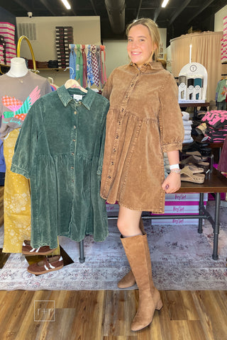 Model wearing the Umgee N7059 mineral wash corduroy babydoll shirt dress in Mocha with Corkys Made You Look Tall Boots, holding the Emerald color on a hanger
