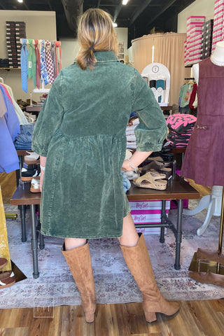 Back view of the Umgee N7059 emerald green corduroy babydoll shirt dress with gathered skirt and Corkys Made You Look Tall Boots