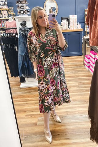 Full-length view of the Umgee olive paisley tiered midi dress K0645 showing the v-neck band collar and 3/4 cuff sleeves, paired with Corkys Knot Gonna Happen gold heeled mules.