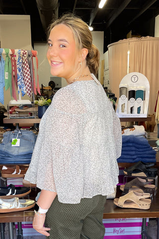 Wishlist Floral Tiered Blouse WL26-13747, close-up of the tiered ruffle hem and bell sleeves over the shoulder view