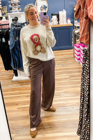 Mirror selfie in the Wishlist Scarf Teddy Bear Graphic Knit Sweater (WL26-13104), styled with Eesome Pleated Elastic-Back Waist Wide Leg Trousers in mocha latte brown and Corkys Layover ballet flats in camel
