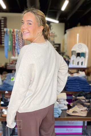 Over-the-shoulder look at the Wishlist Scarf Teddy Bear Graphic Knit Sweater (WL26-13104) showing the relaxed, oversized fit, styled with Eesome Pleated Elastic-Back Waist Wide Leg Trousers in mocha latte brown