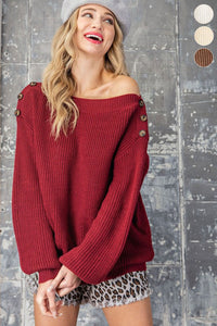 ee:some burgundy ribbed sweater with balloon sleeves and button detailing on the shoulders 
