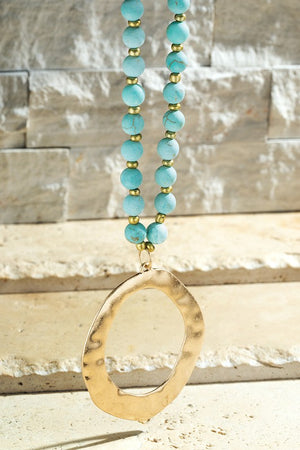 turquoise stone with gold bead long necklace and gold hammered circle pendant