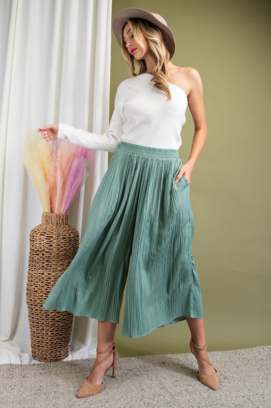 ee:some flowy wide leg midi length pants in a plisse pleated design in sage