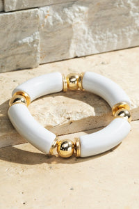 white resin stretch bracelet with gold bead accents